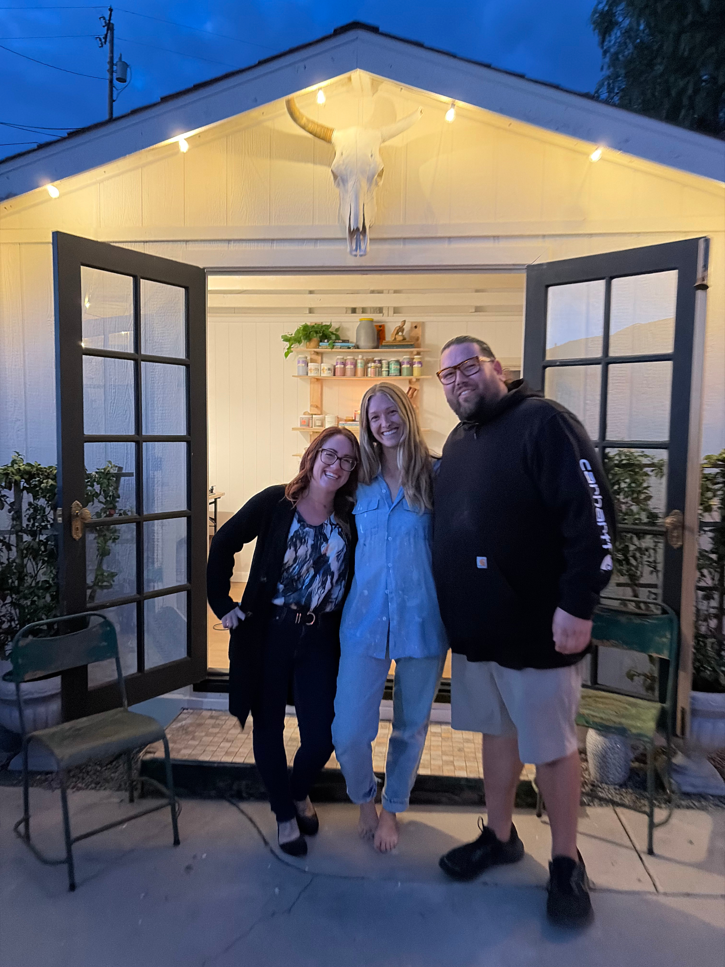 Guests standing together in front of The Mudroom at dusk