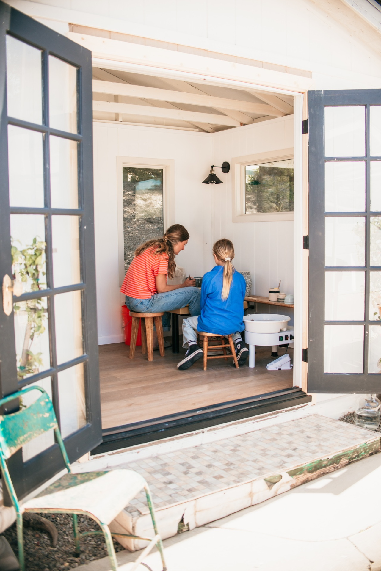 View through open French doors into The Mudroom with a class in session